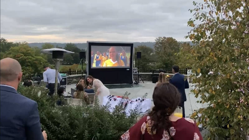 Video projection with speakers at outdoor wedding venue