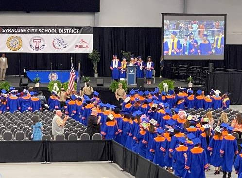 Indoor graduation with large screens